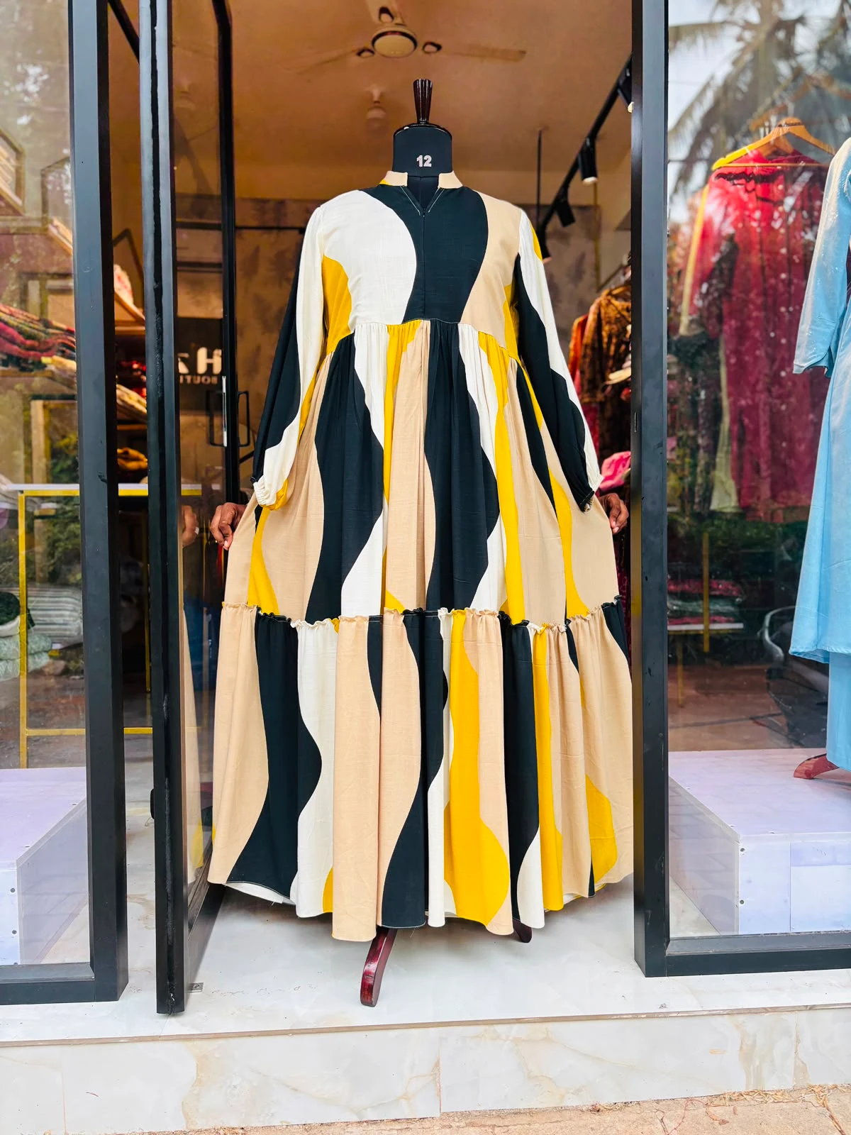 A Dress form wearing a two layer luxury gown with feeding option online maternity wear in kerala