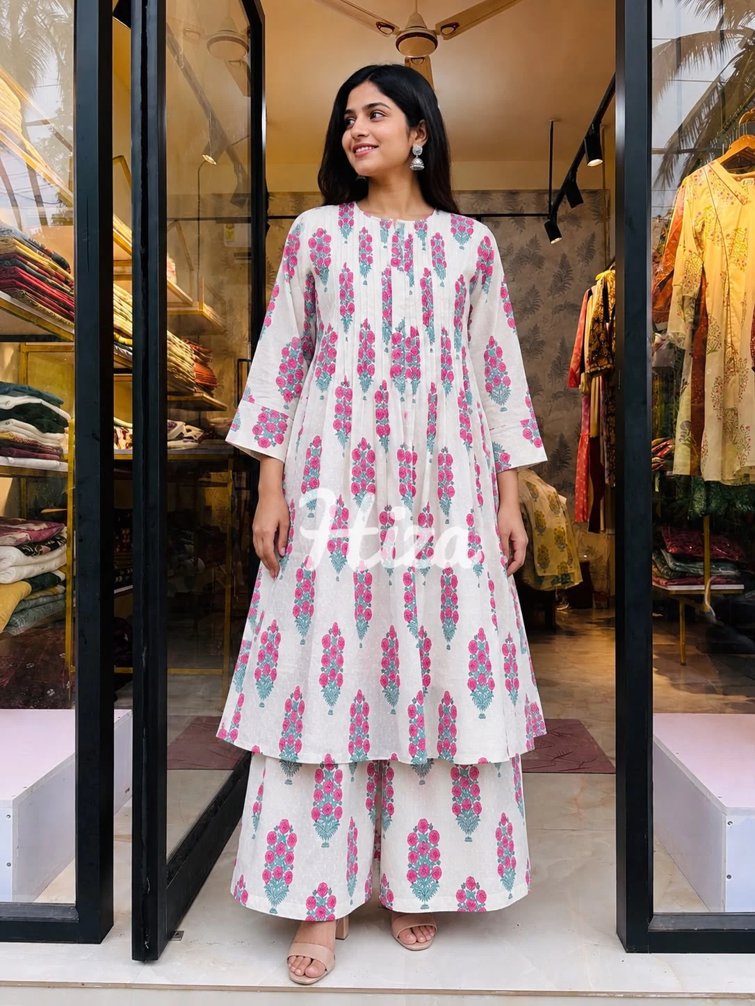 a young women wearing a rani color and white compination feeding co-ord set-online maternity wear in kerala